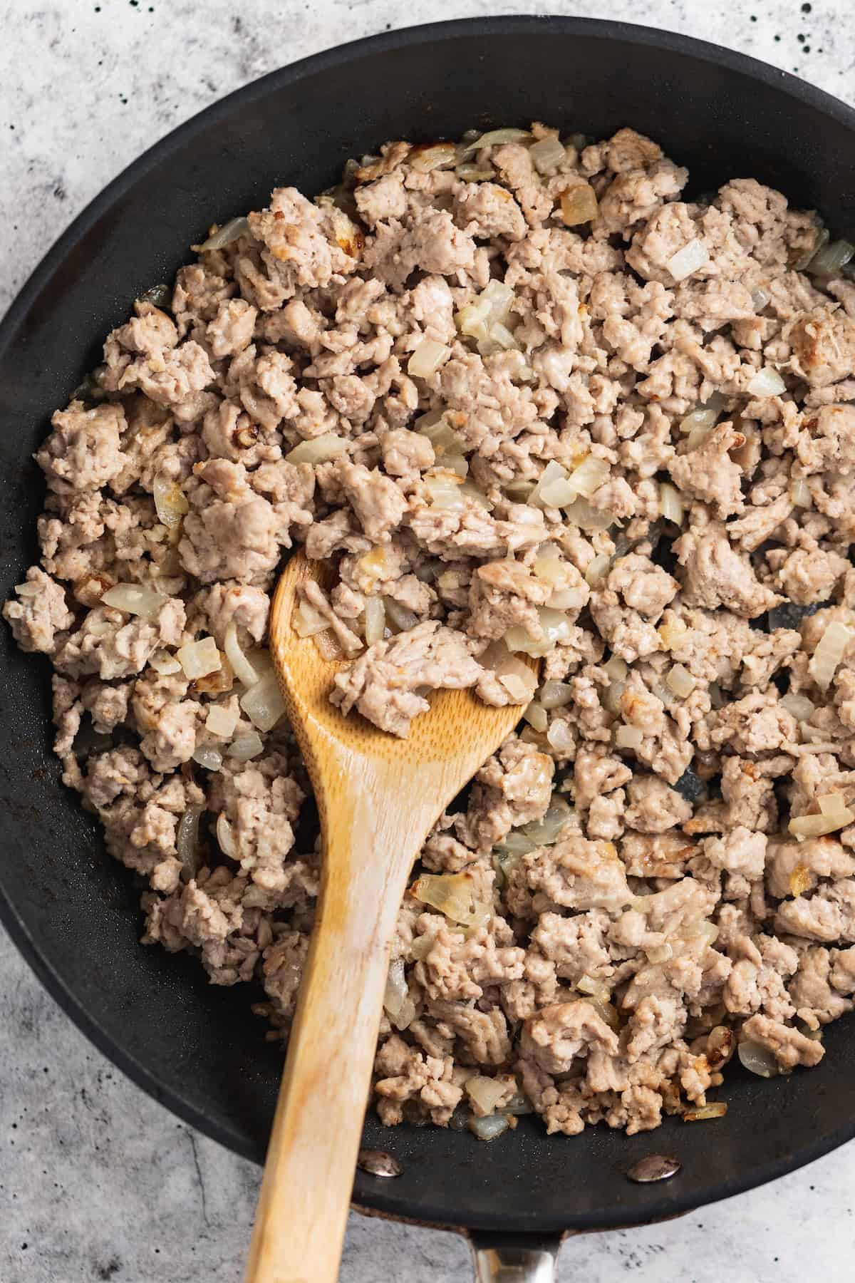 Cooking the ground chicken in the pan.