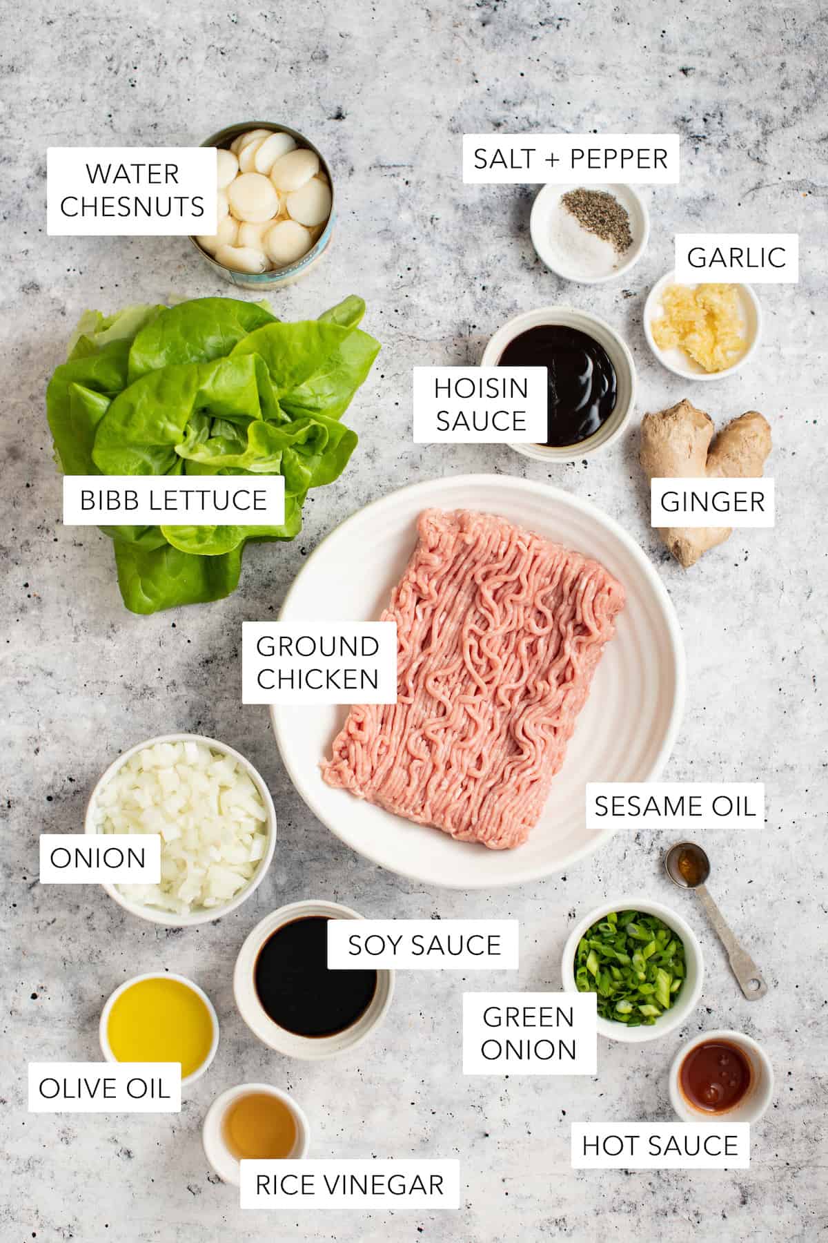 Ingredients for chicken lettuce wraps in small white bowls