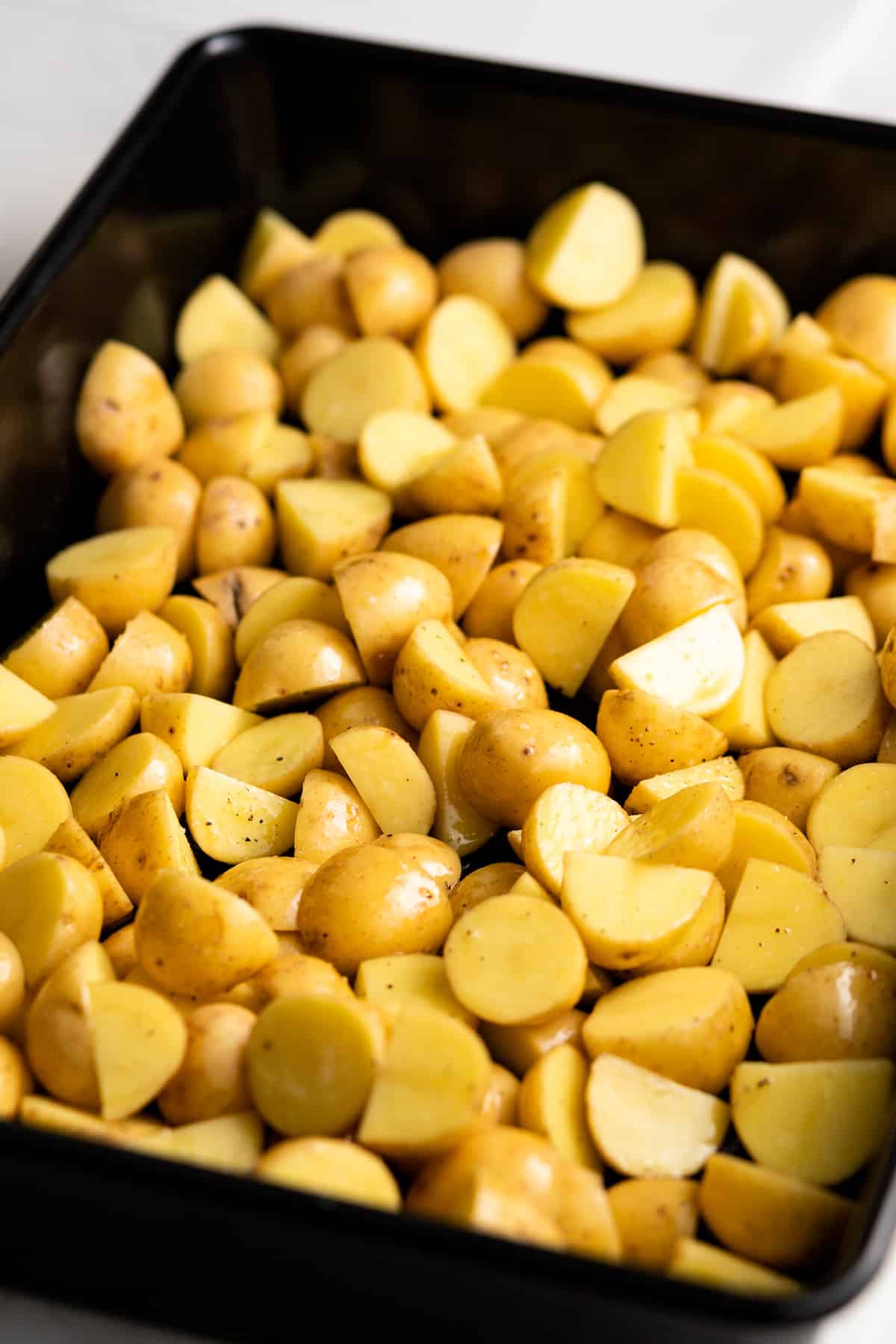 Chopped potatoes in the baking dish.