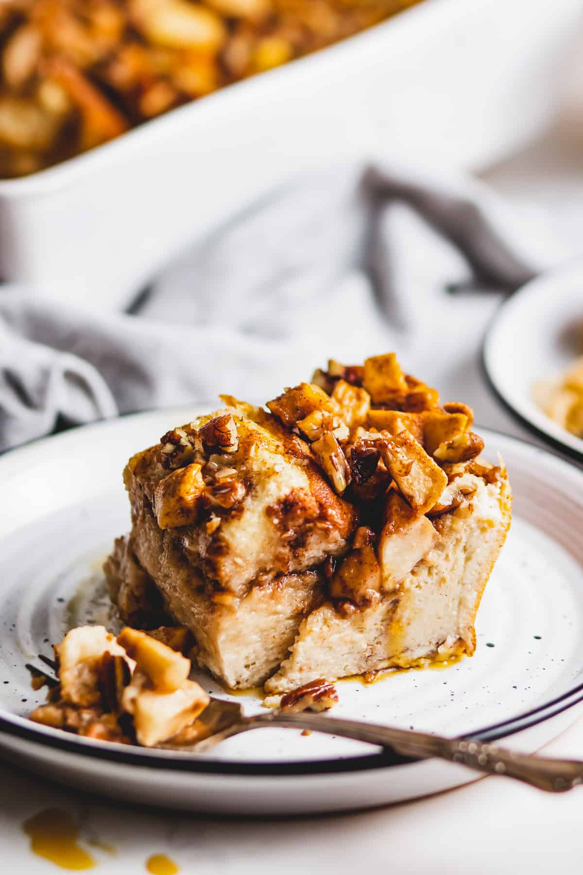 Slice of apple cinnamon French toast bake on a plate.