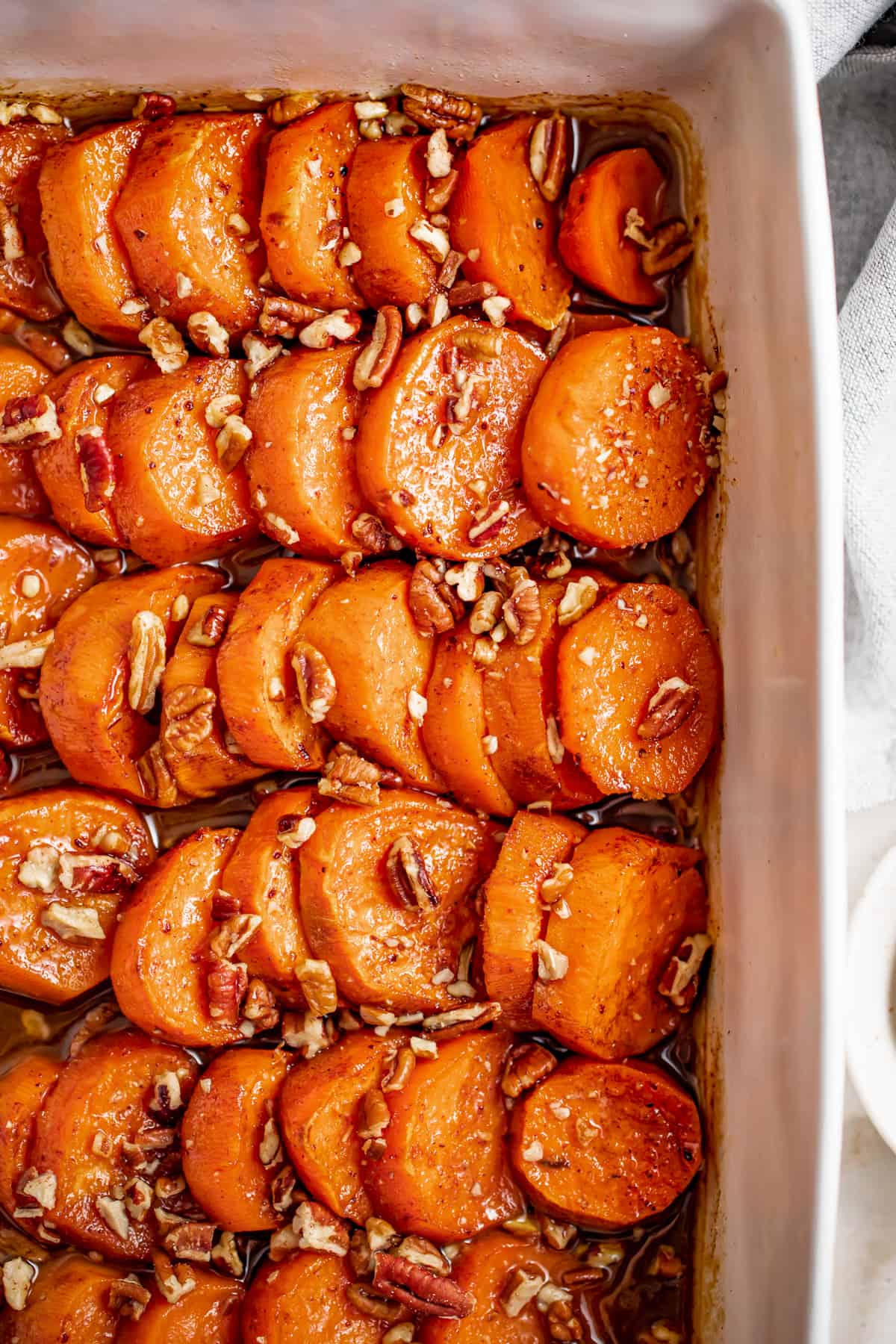 Baked candied yams without pecans in the baking dish.