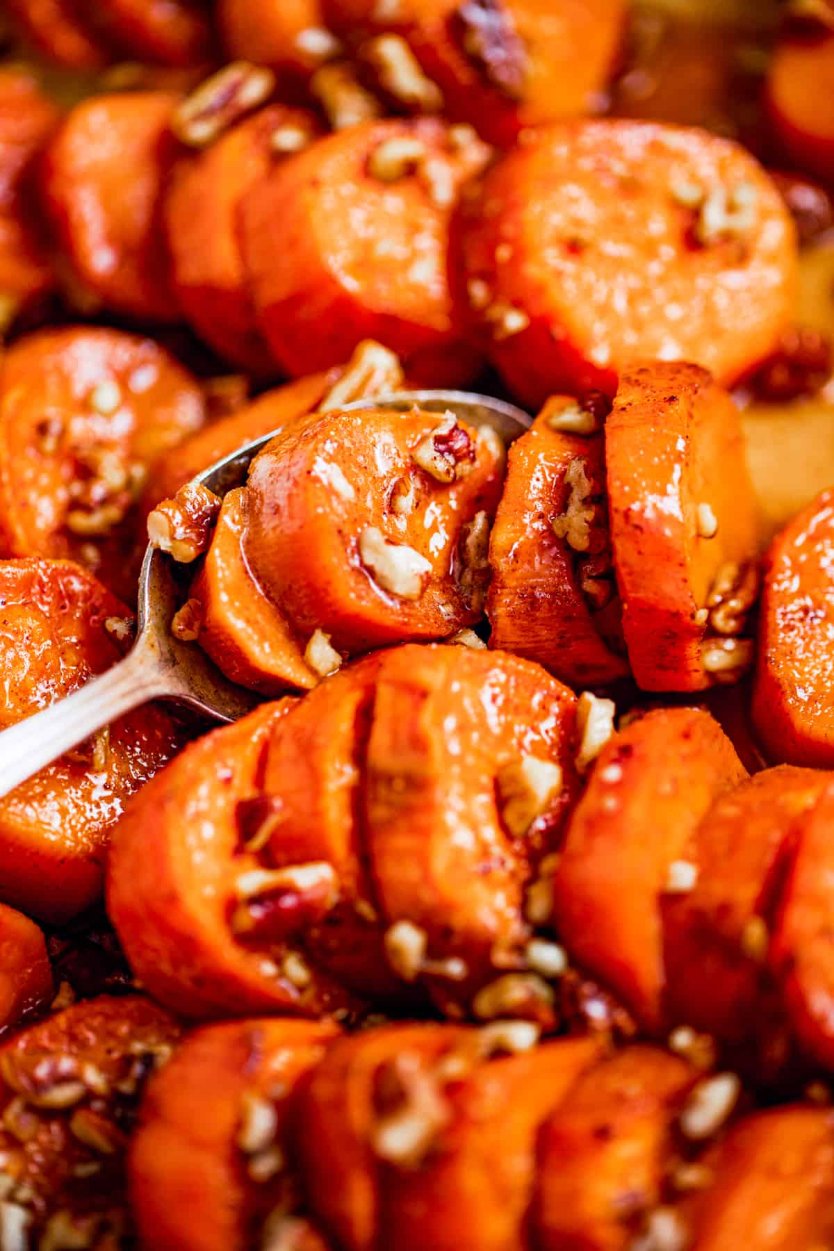 Close-up of Southern candied yams with chopped pecans.