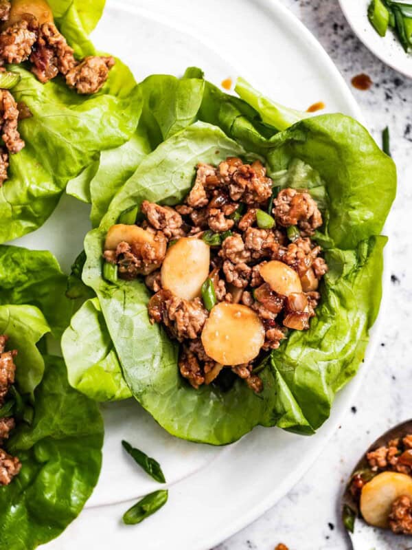 Asian chicken lettuce wraps served on a plate.