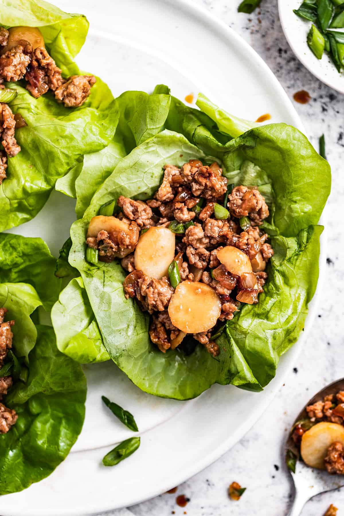 Asian chicken lettuce wraps served on a plate.