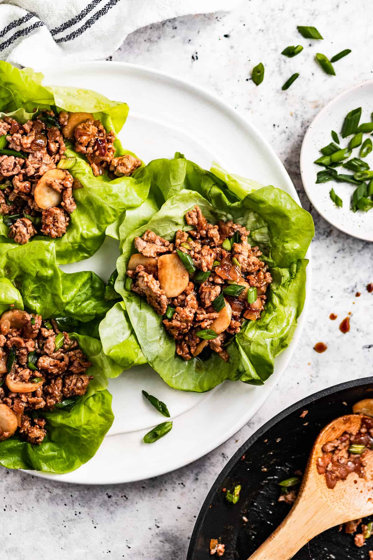 Asian chicken lettuce wraps served on a plate.