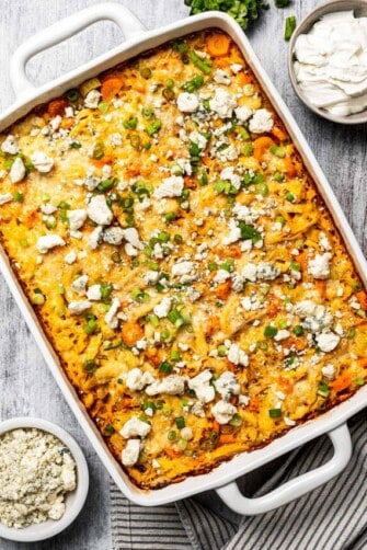 A buffalo-style chicken casserole with rice and toppings.