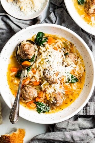 Bowl of Italian wedding soup with parmesan.