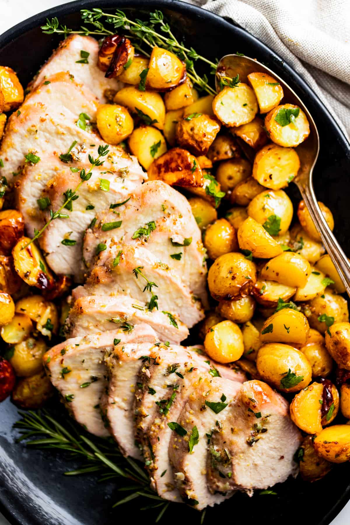 Sliced pork tenderloin with roasted potatoes.