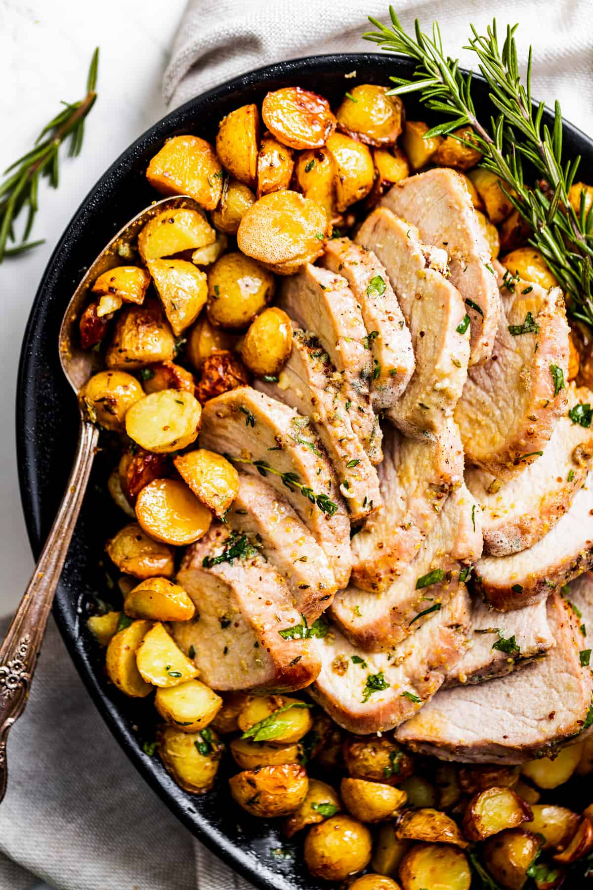 Sliced pork tenderloin with roasted potatoes.