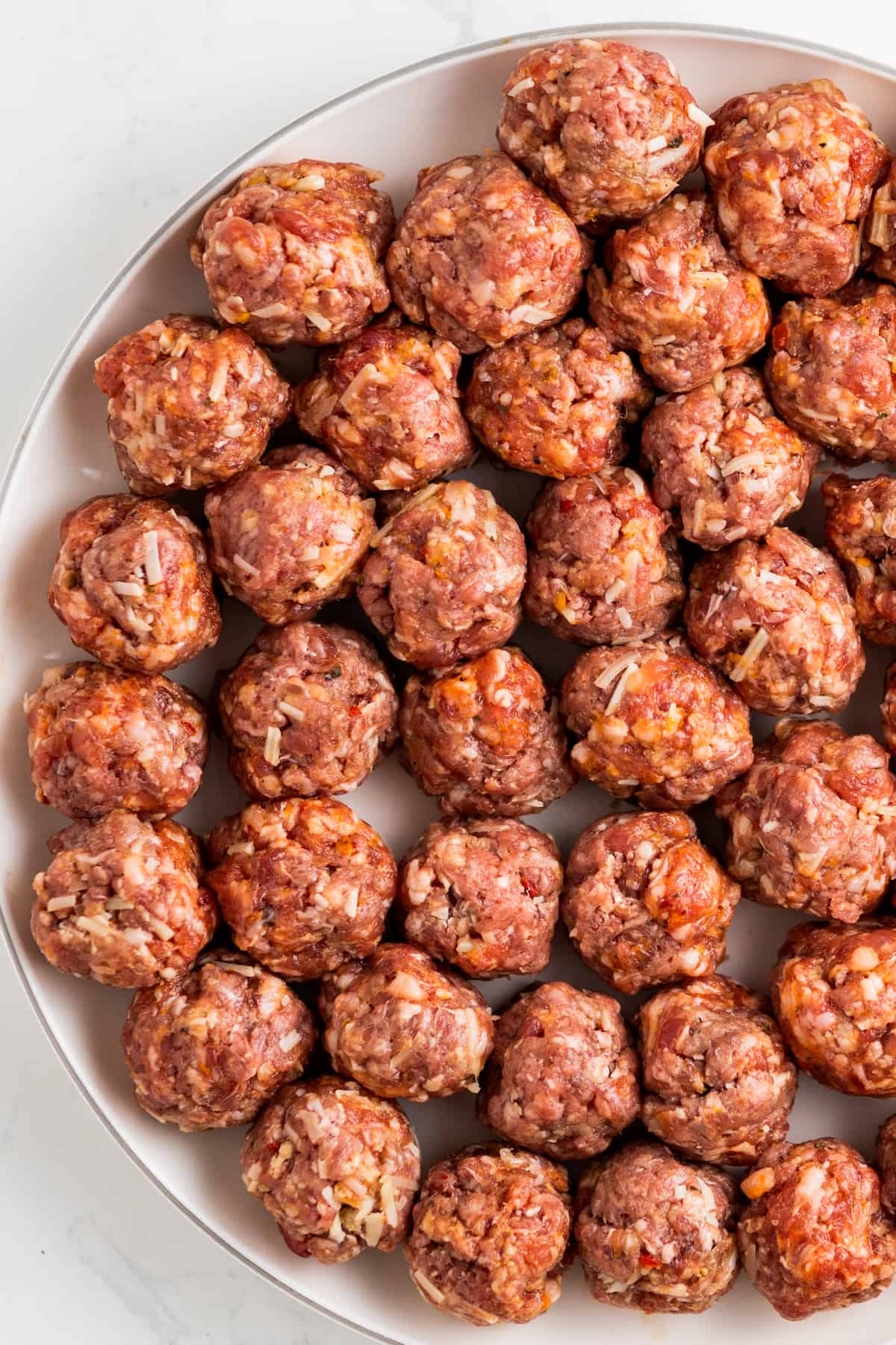 Rolled meatballs in a large plate.