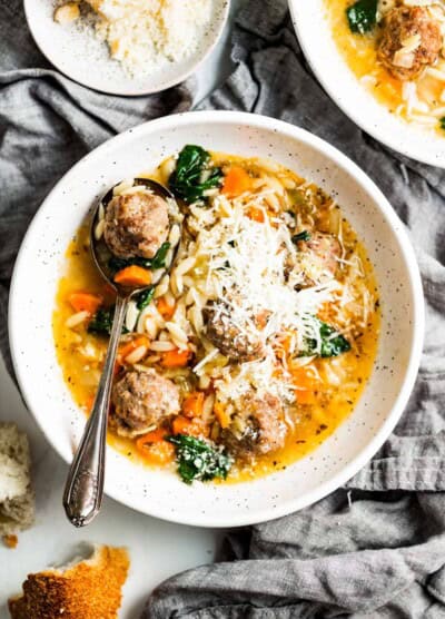 Bowl of Italian wedding soup with parmesan.
