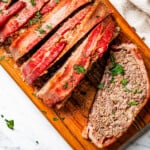 Slicing the loaf on a cutting board.