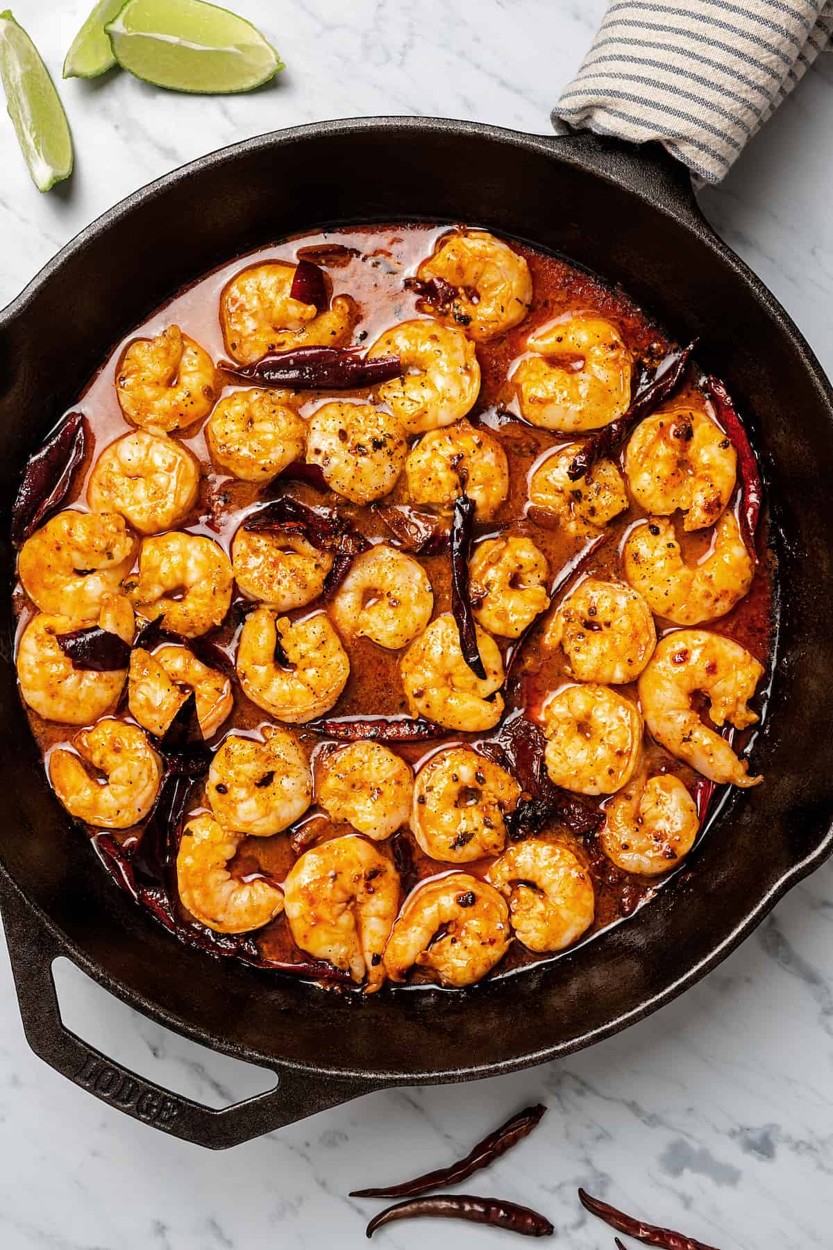 Mixing the shrimp and sauce in the pan.