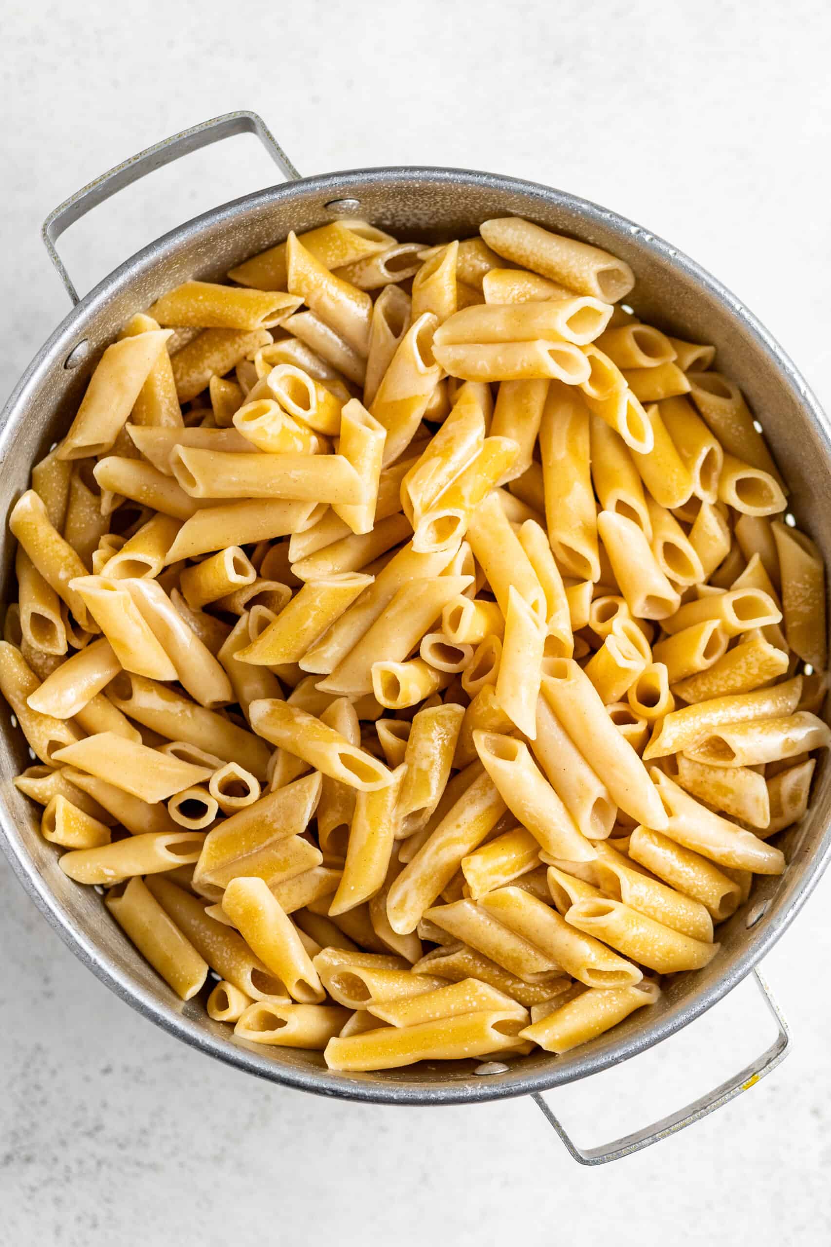 Cooked penne pasta in a pot.