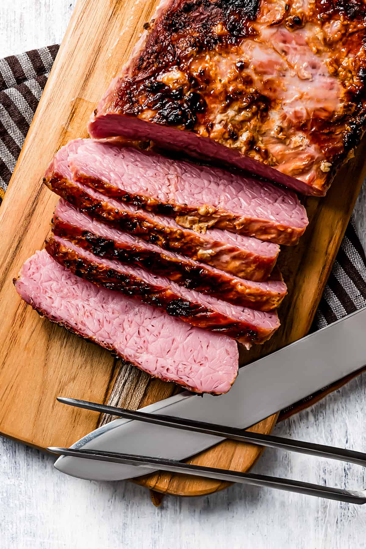 Sliced corned beef on a cutting board.