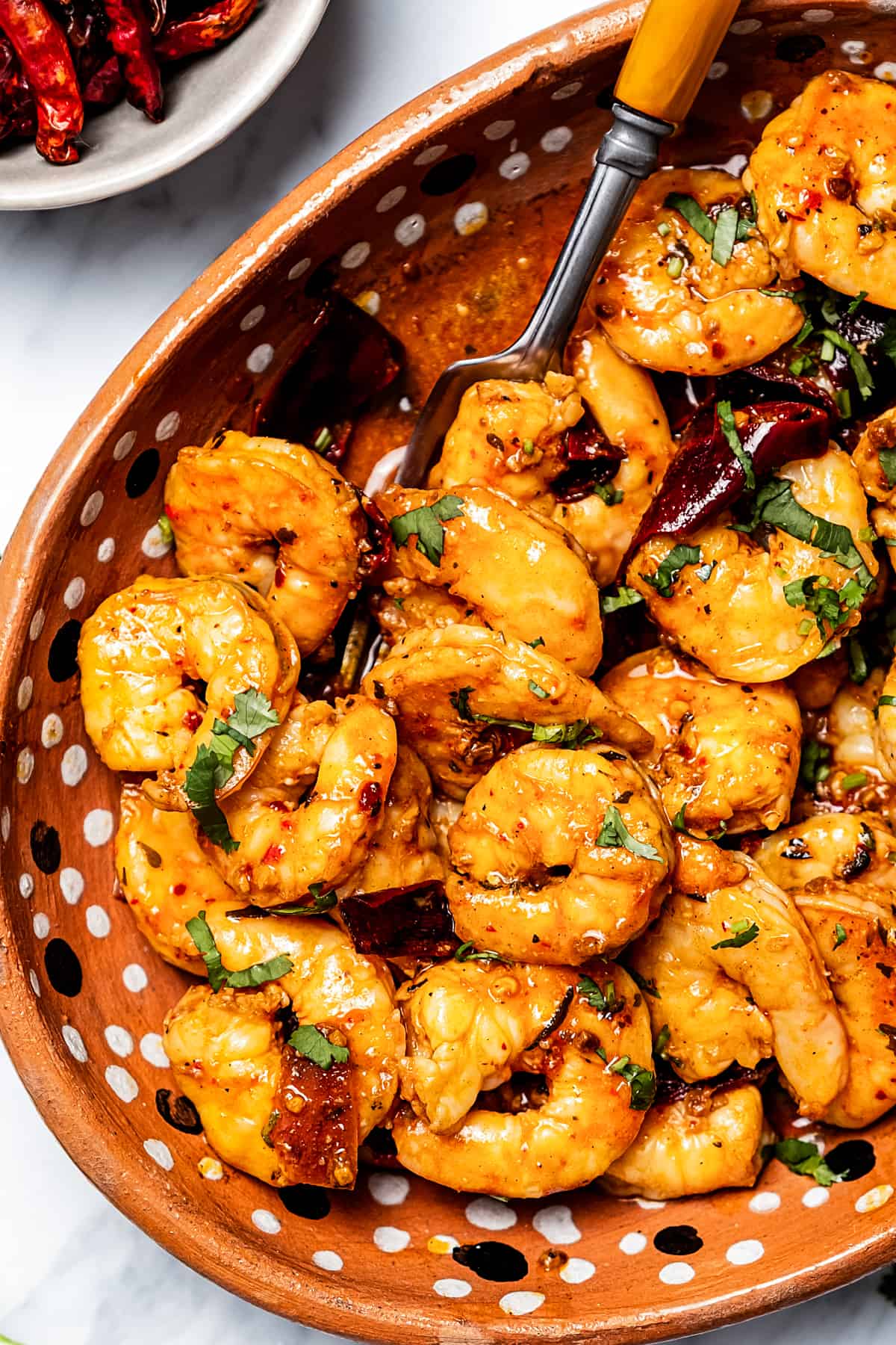 Close-up shot of garlic shrimp in a serving dish.