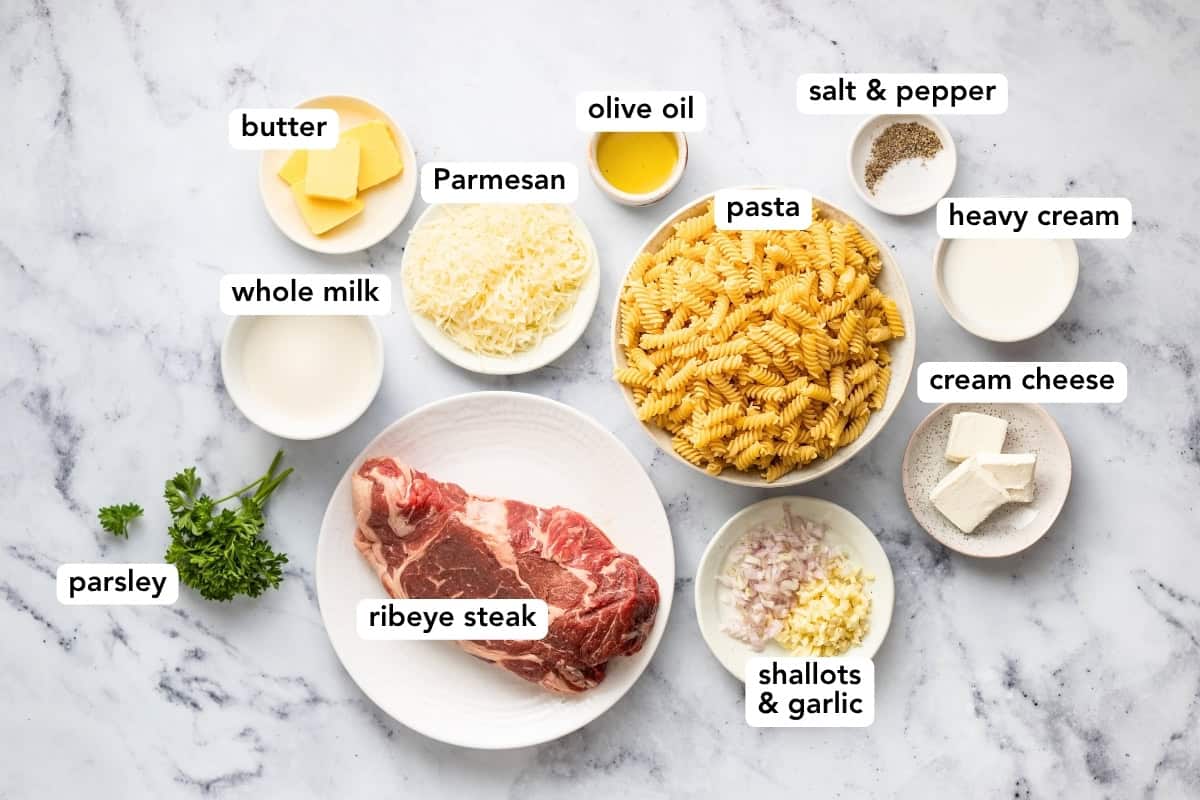With tender, juicy steak and cheesy cream sauce, this steak Alfredo with pasta is a rich, restaurant-quality meal that's easy to make at home. Ingredients to make steak alfredo are arranged on a working surface.