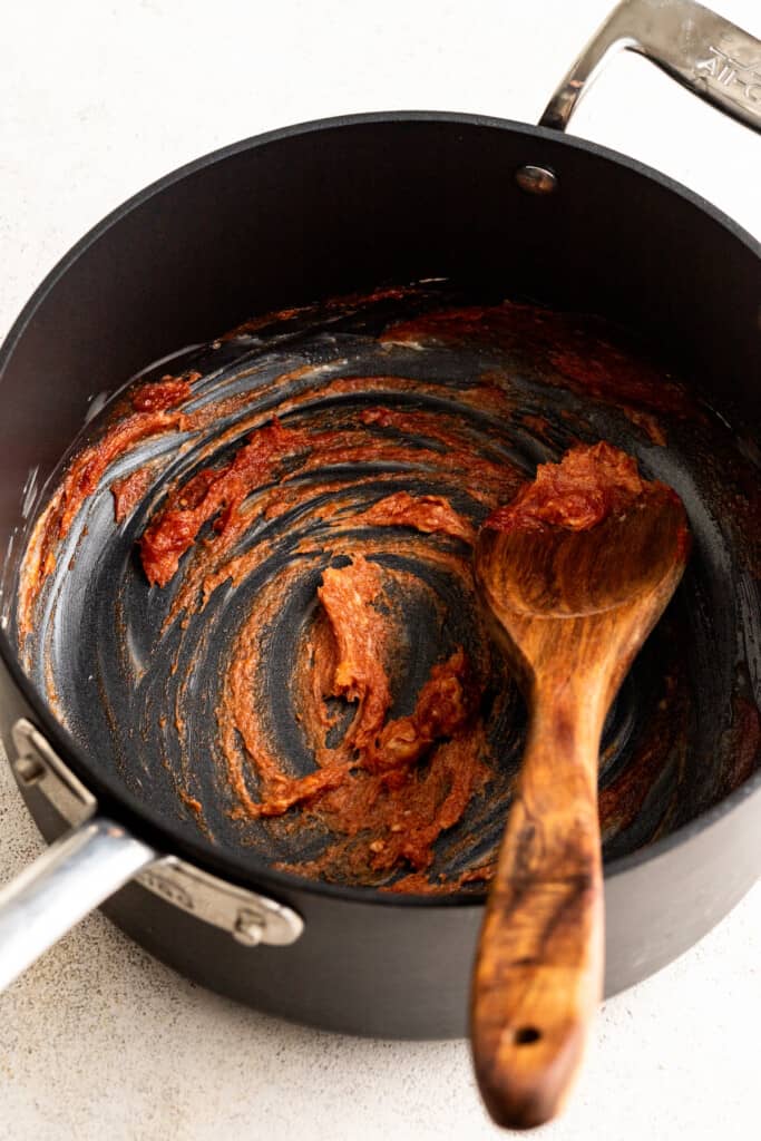 Cooking tomato paste in a saucepan.