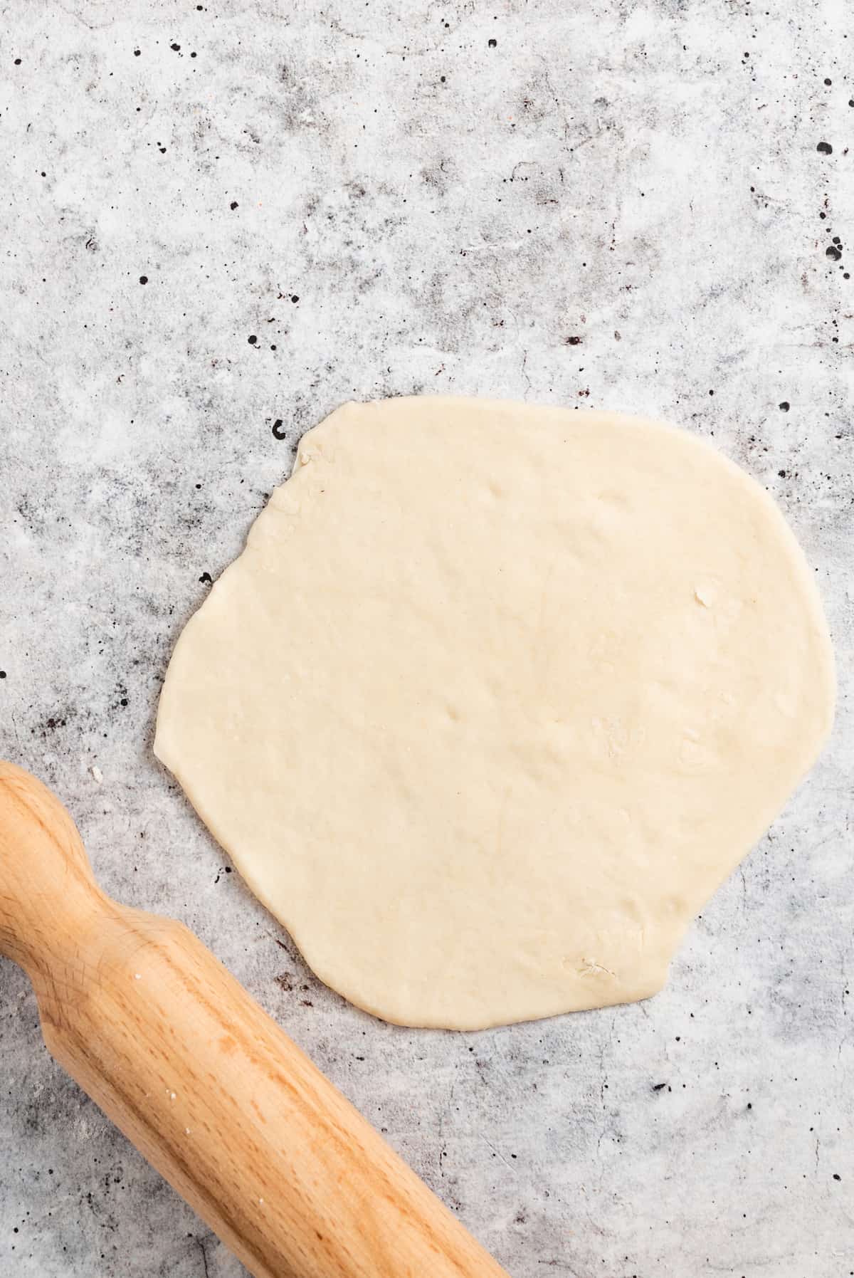 Flattening the dough.
