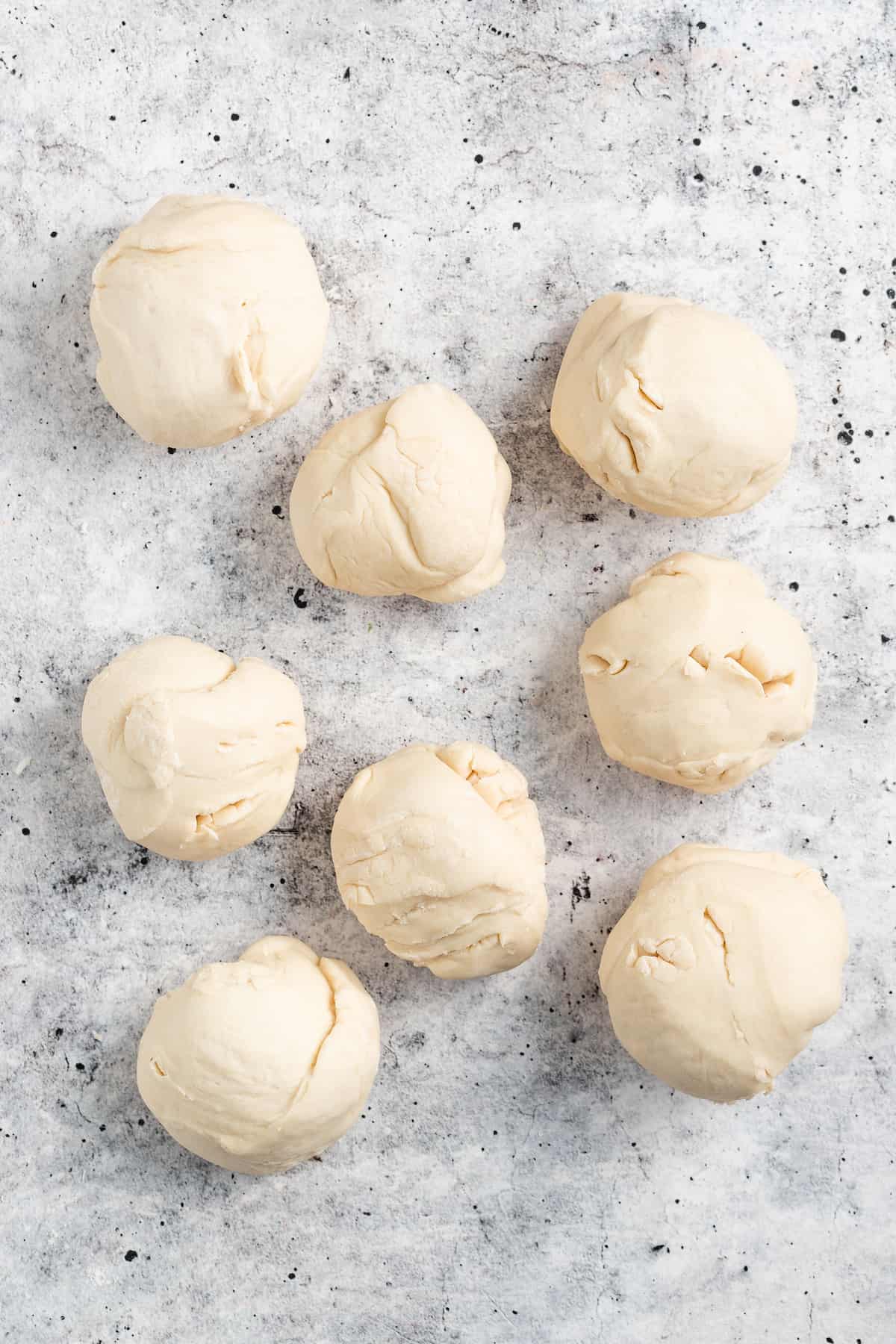Rolling the pieces of dough into little balls.