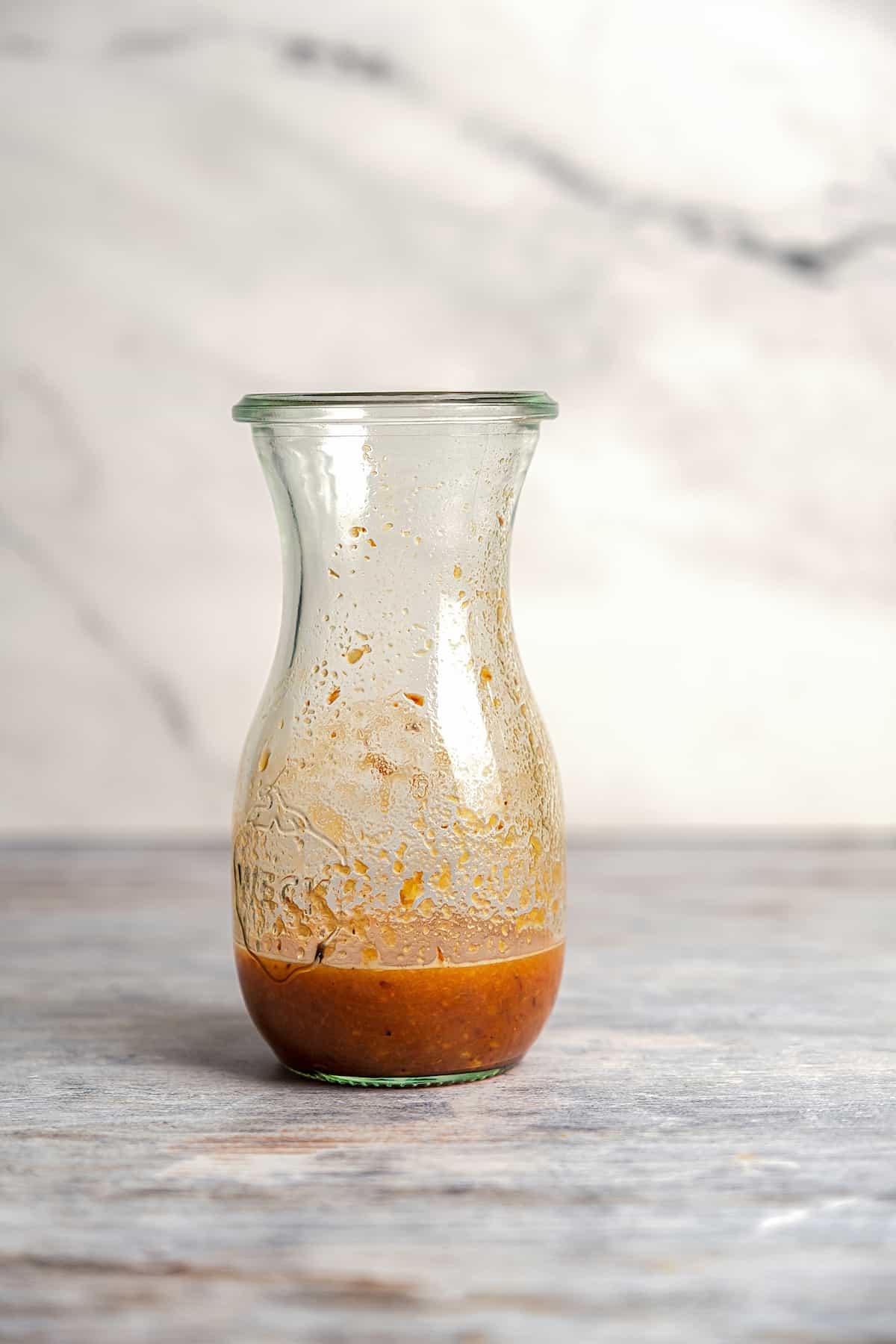 Spicy chutney in a glass container.