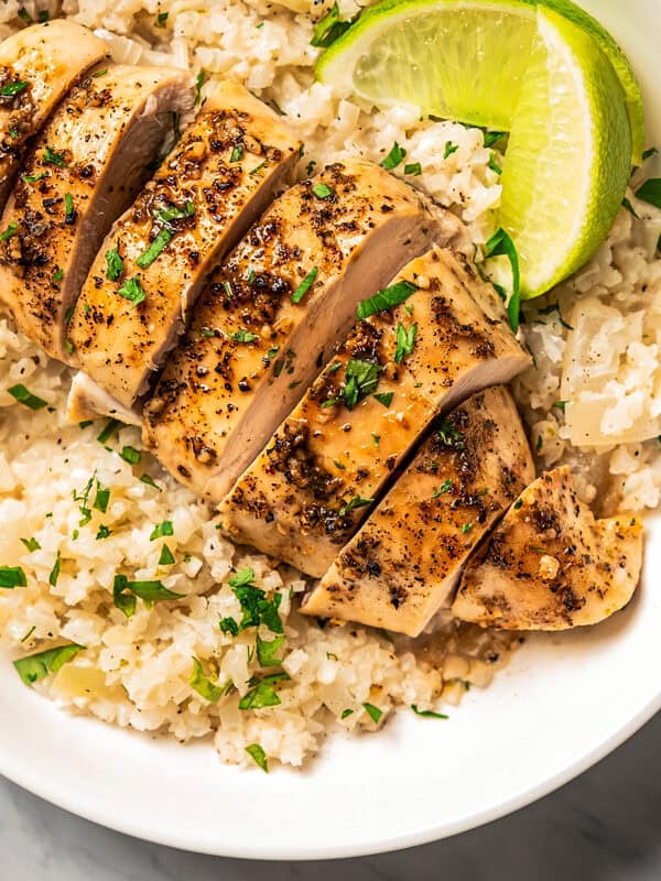 Baked and sliced chicken breast served over rice.