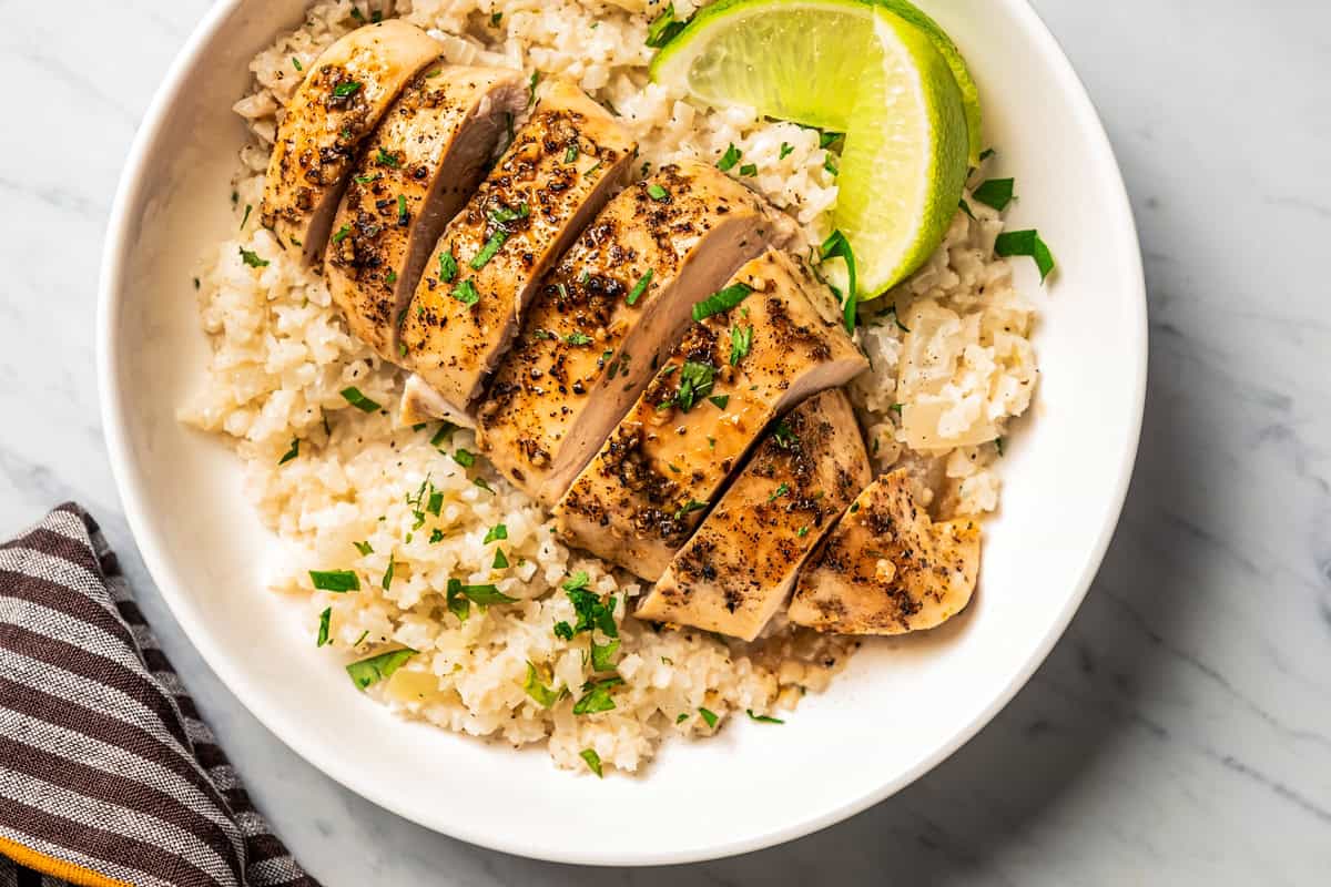 Baked and sliced chicken breast served over rice.