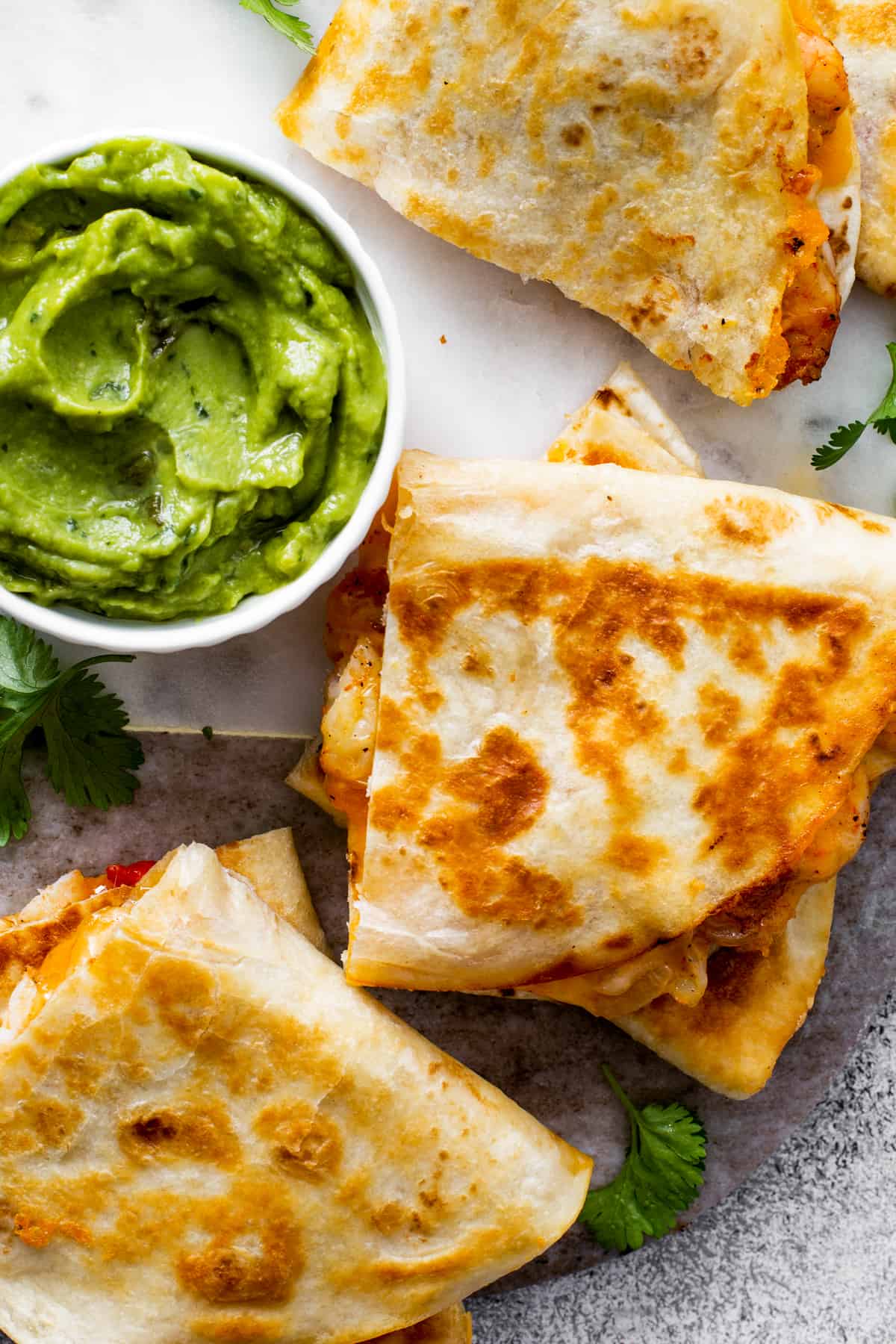 breakfast quesadillas with red pepper and cilantro served with guacamole
