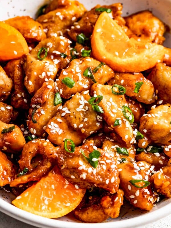 bowl with mandarin chicken and a garnish of sesame seeds over the chicken pieces.