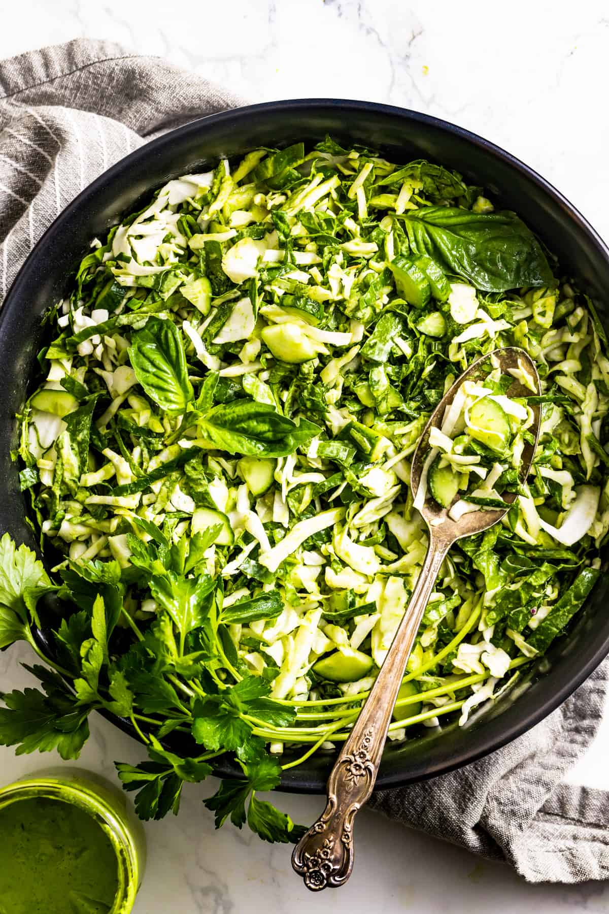 TikTok Green Goddess Salad in a bowl with dressing on the side.
