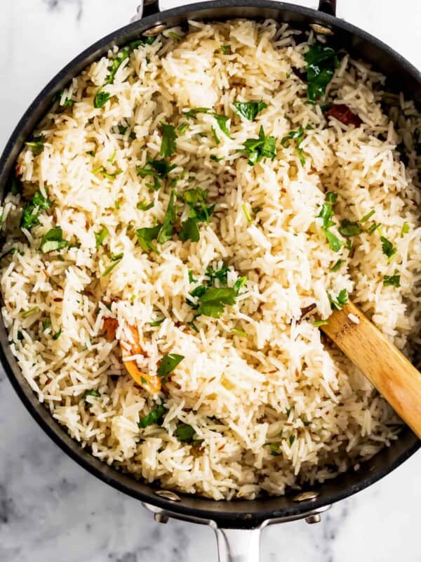 mixing fresh cilantro into rice.