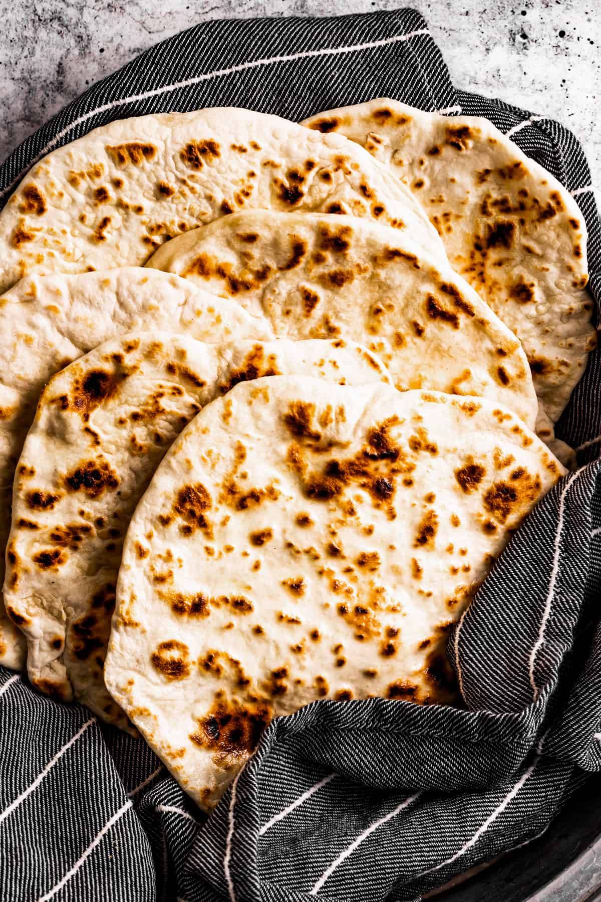lavash armenian flatbread wrapped in a gray kitchen towel.