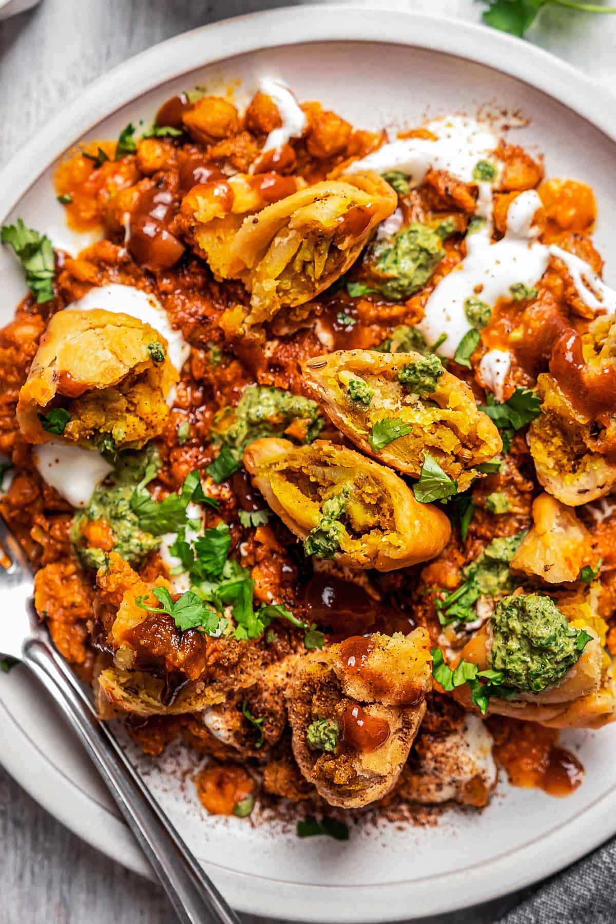 Overhead shot of Indian samosa chaat on a plate.