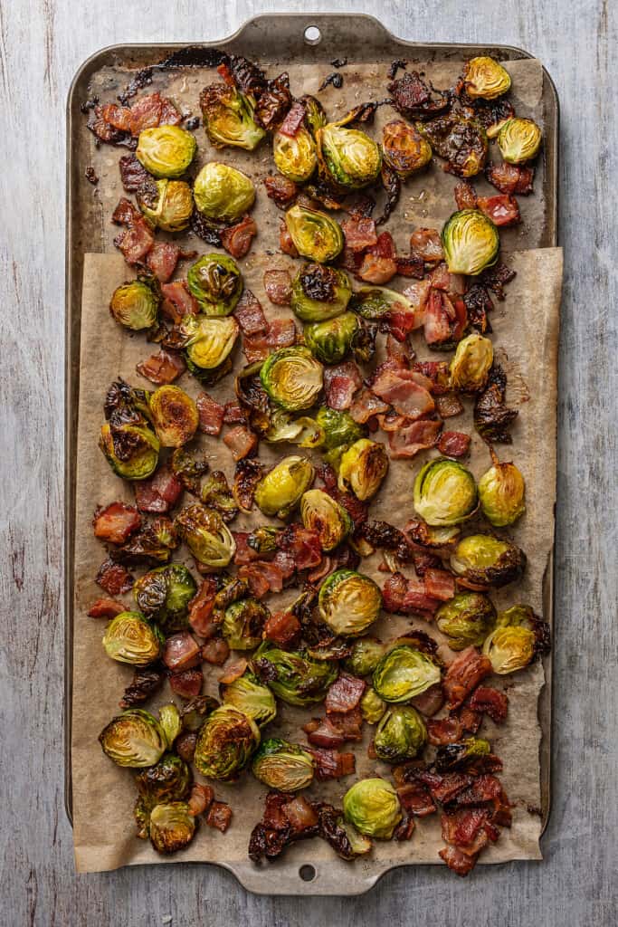 Roasted Brussels sprouts and bacon on a sheet pan.