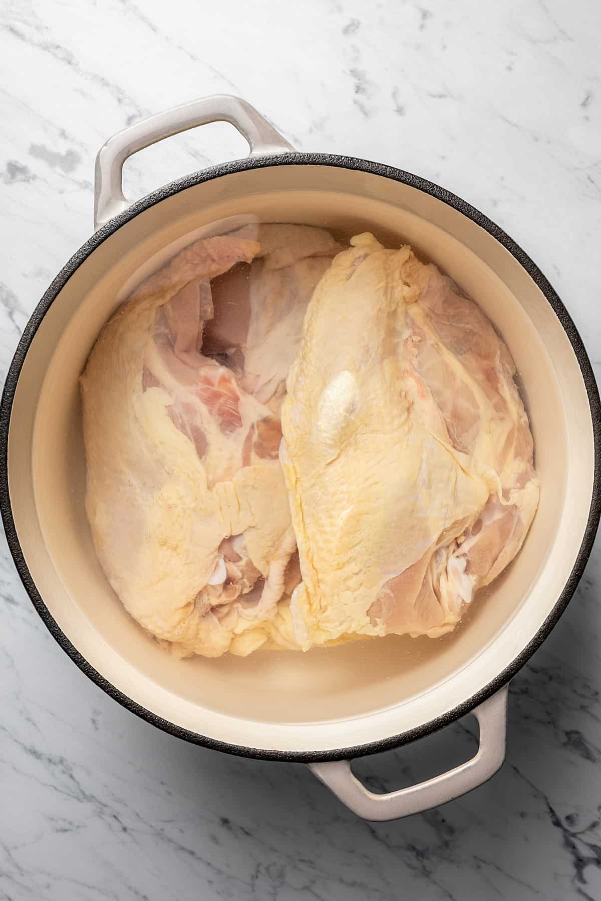 Chicken and water in a pot.