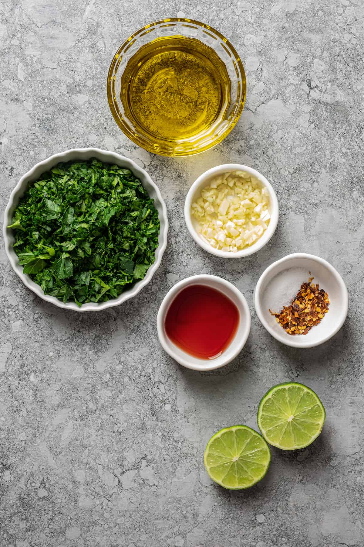 Ingredients for chimichurri separated into bowls.