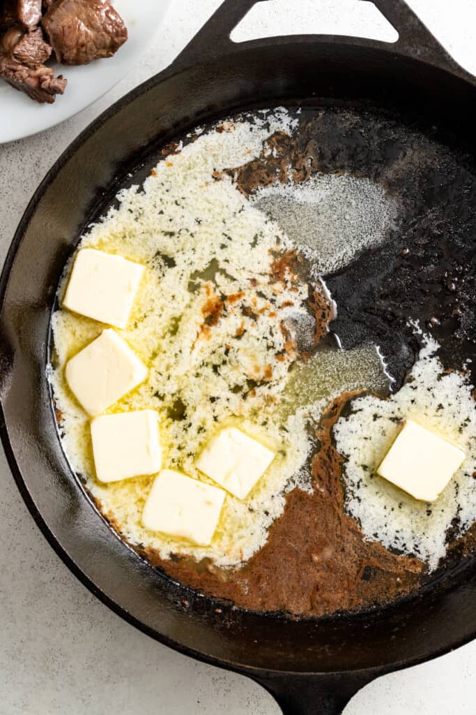 Melting the butter in the pan. 