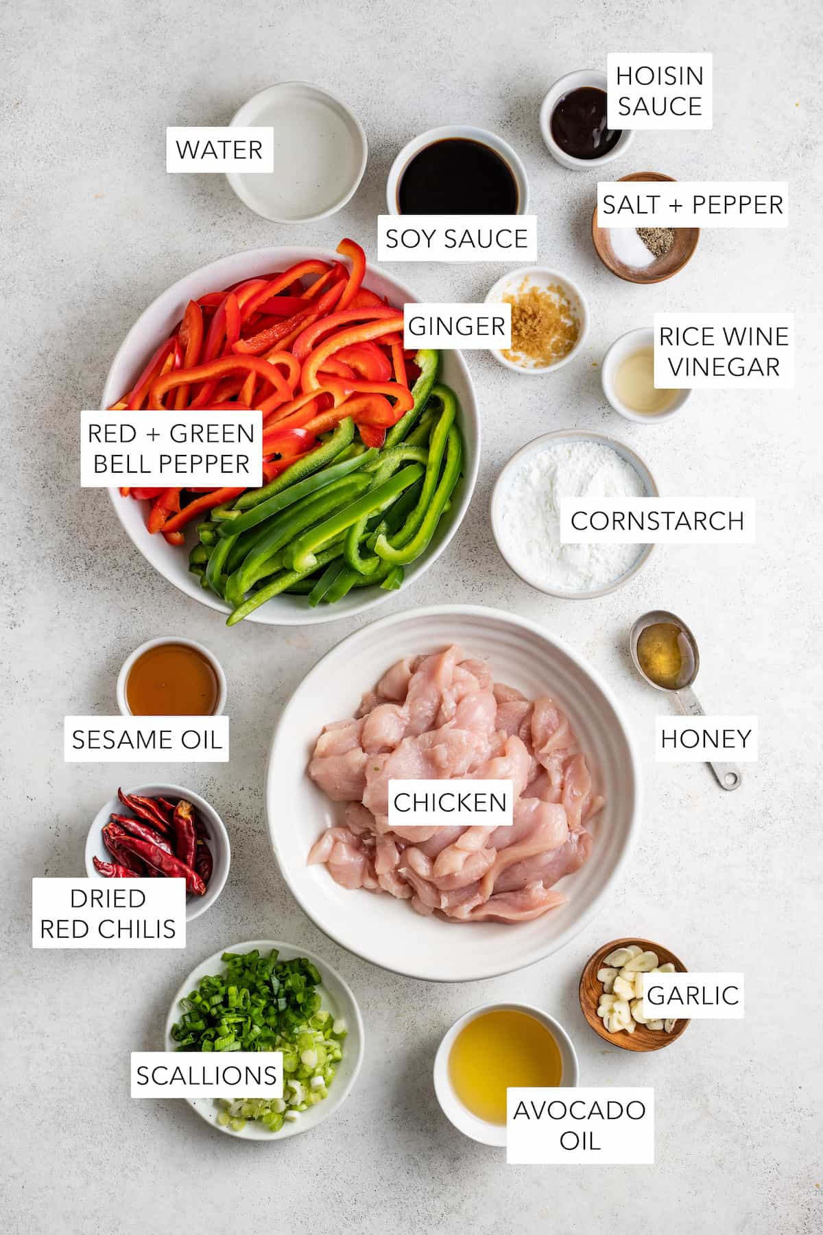 Ingredients for Szechuan chicken separated into bowls and labeled.
