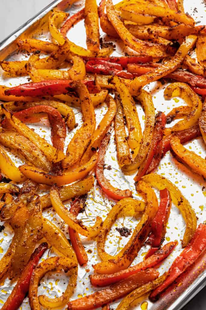 Roasted bell peppers on a sheet pan.