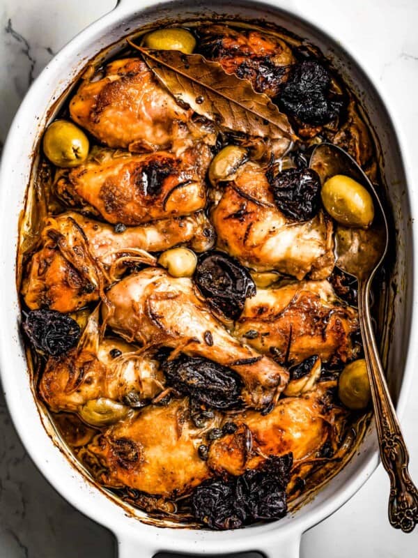 overhead shot of caramelized chicken Marbella in a baking dish.