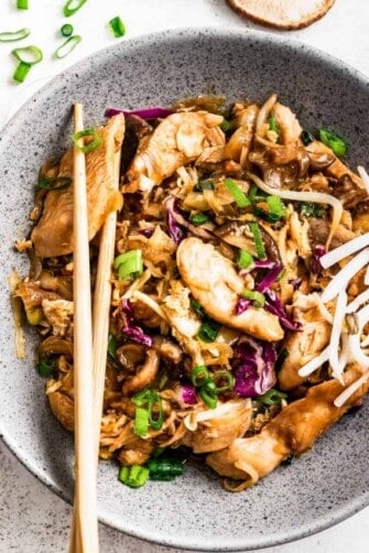 Moo shu chicken in a bowl with chopsticks.