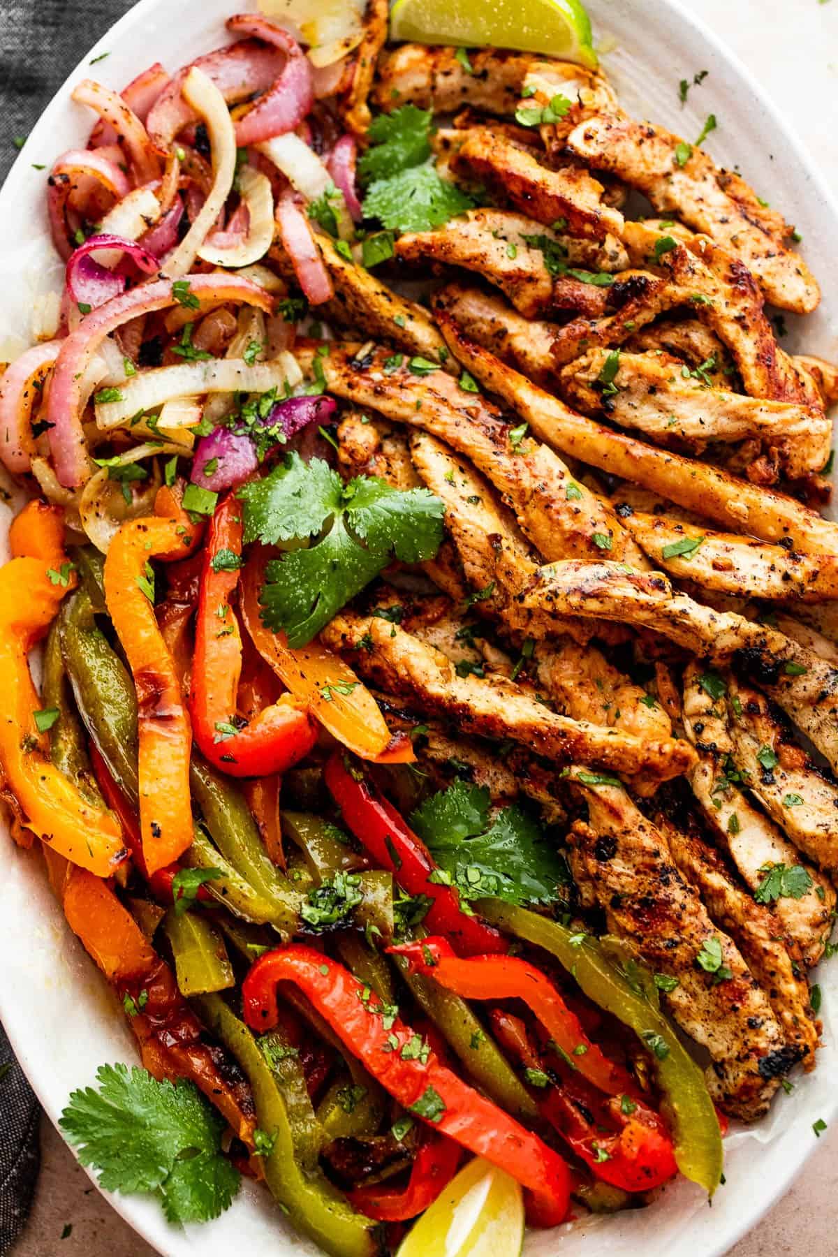 Grilled Chicken Fajitas Served on an oval platter.