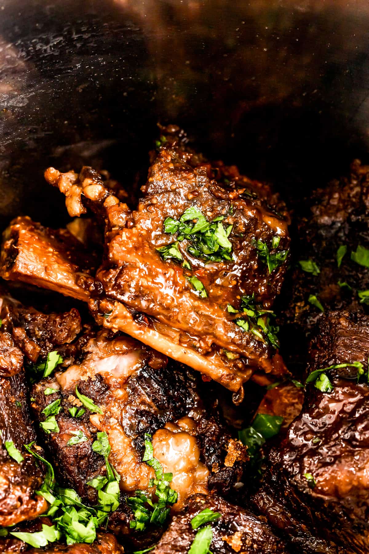 Close-up of instant pot short ribs with fresh parsley.