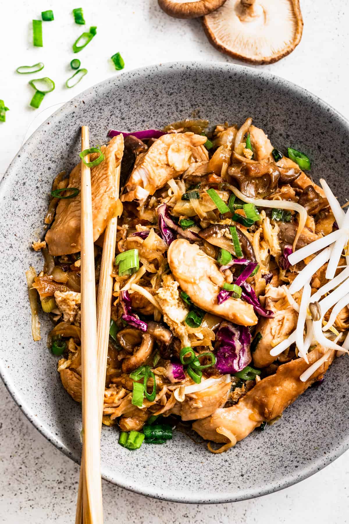 Moo shu chicken in a bowl with chopsticks.