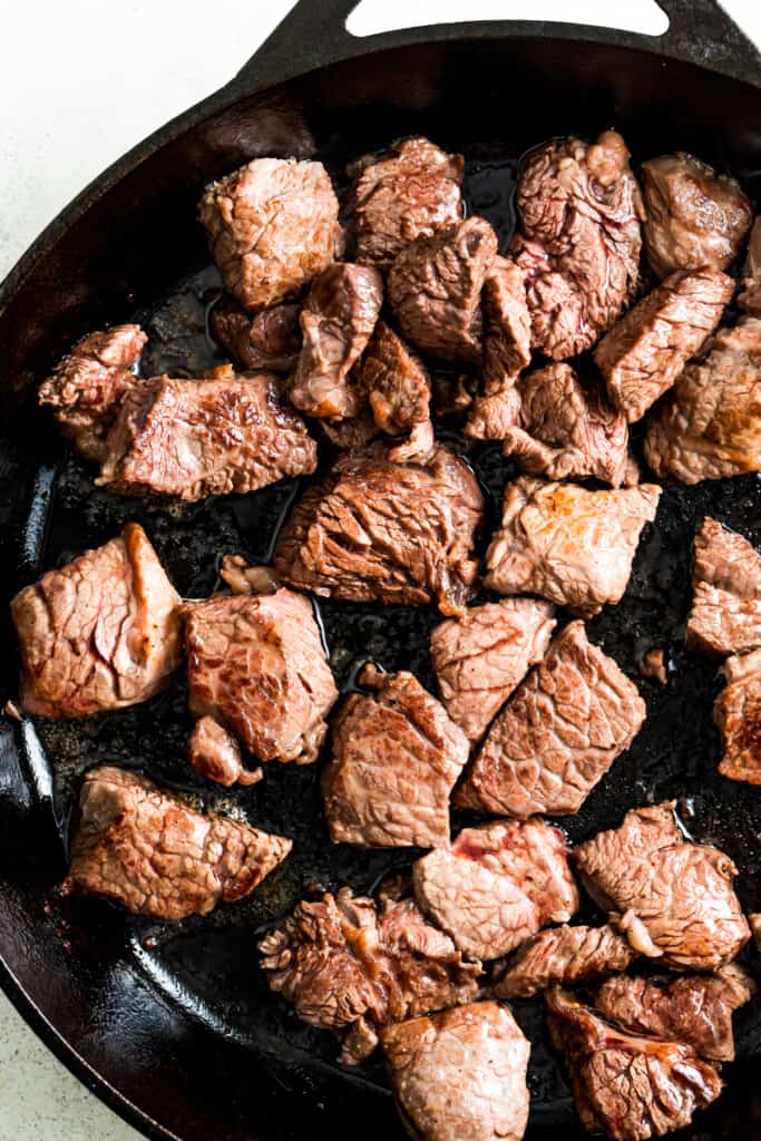 Browning the steak bites in the pan.