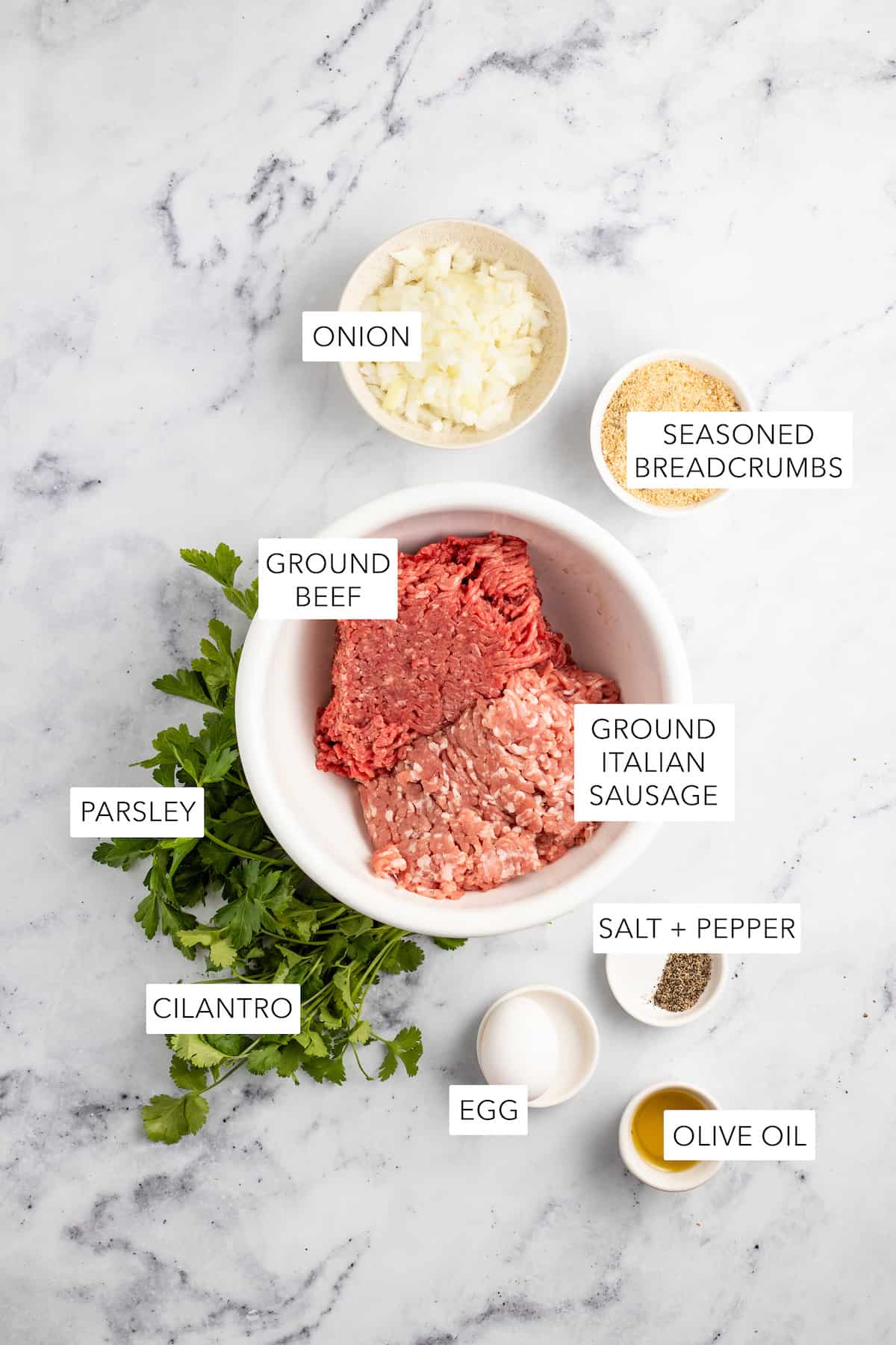 Ingredients for air fryer meatballs labeled and separated into bowls.