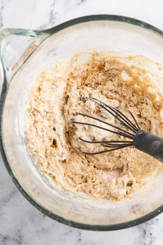 Whisking dry ingredients into muffin batter.