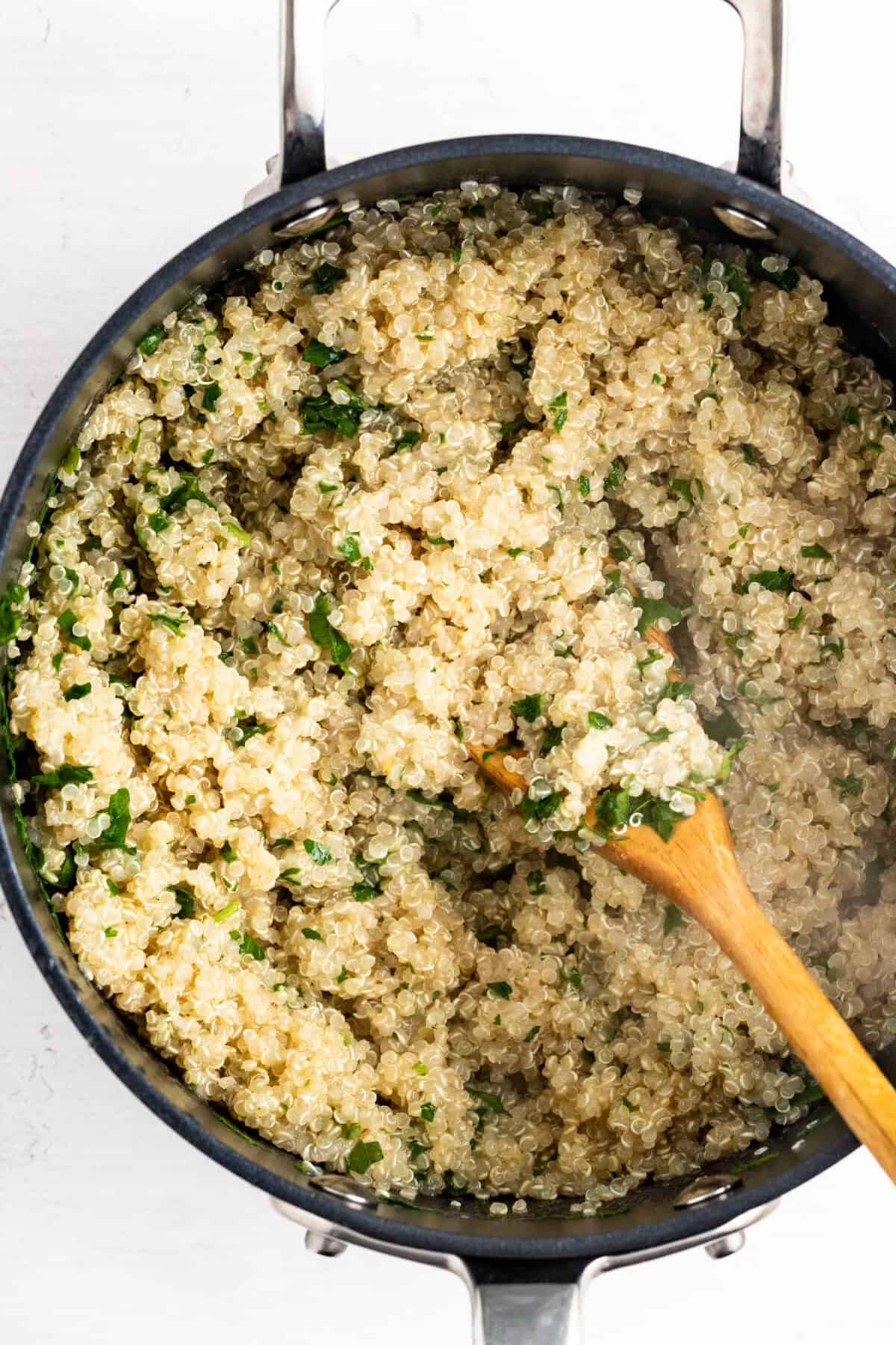 Cooking quinoa in a dark pan.