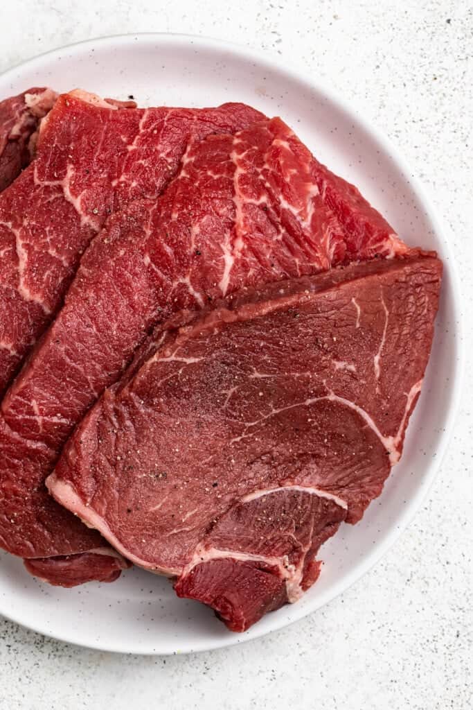Seasoned steak ready to be seared.