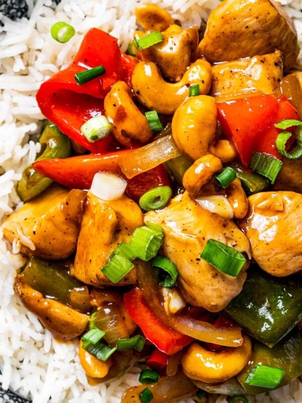 Close up overhead view of a plate of cashew chicken served on rice.